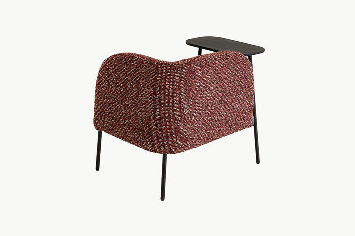 Detailed view of the luxurious textured bouclé upholstery in deep red tones on the Angela Armchair backrest
