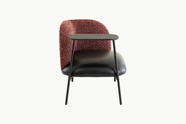 Close-up of the integrated square black side table on the Angela Armchair, perfect for holding drinks or books