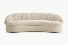 Side view of Candy curved 3-seater sofa in boucle fabric showing rounded silhouette and base