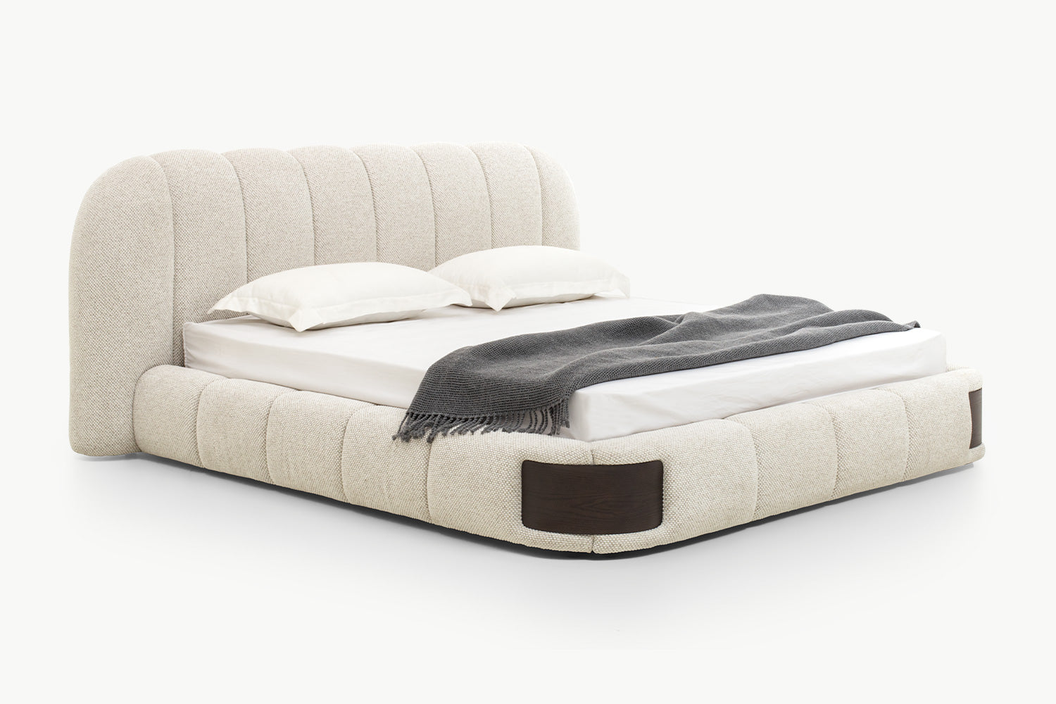 Close-up of padded base with segmented cushioned panels and inset dark walnut wood side panels, emphasizing high-end craftsmanship and structural elegance