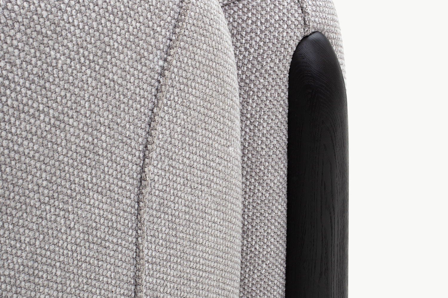 Close-up scalloped channel tufting and pillow on beige boucle Chirs 1-seater sofa