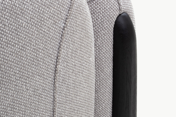 Close-up scalloped channel tufting and pillow on beige boucle Chirs 1-seater sofa