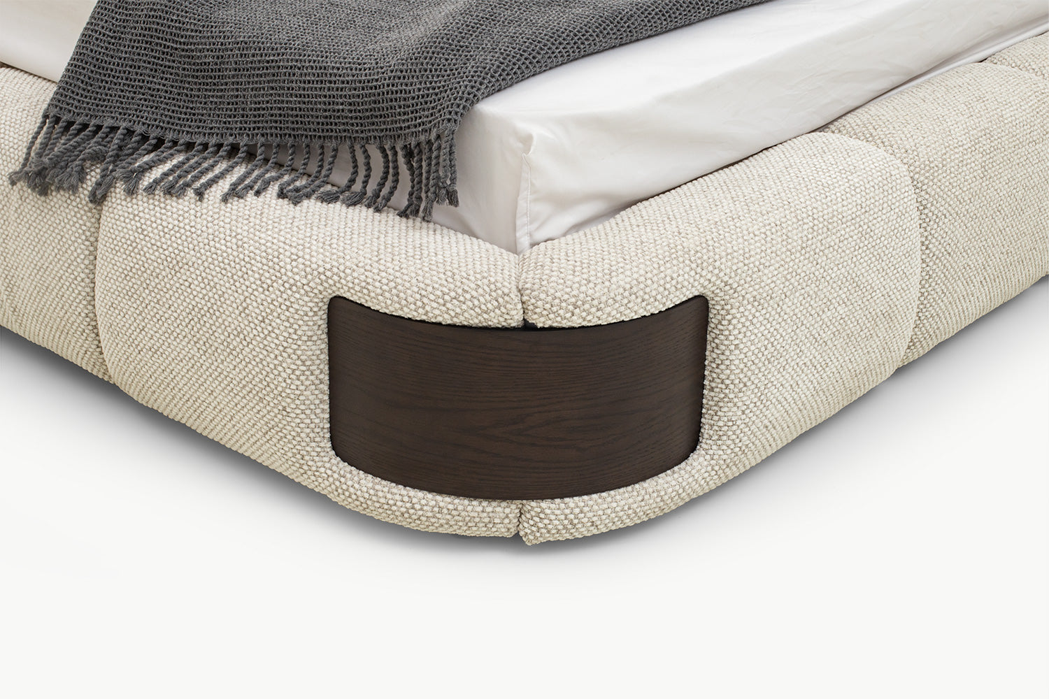 Elegant Bedroom Bed close-up of rounded corner cushioning and rich walnut wood panel inset, showcasing seamless integration and premium material contrast
