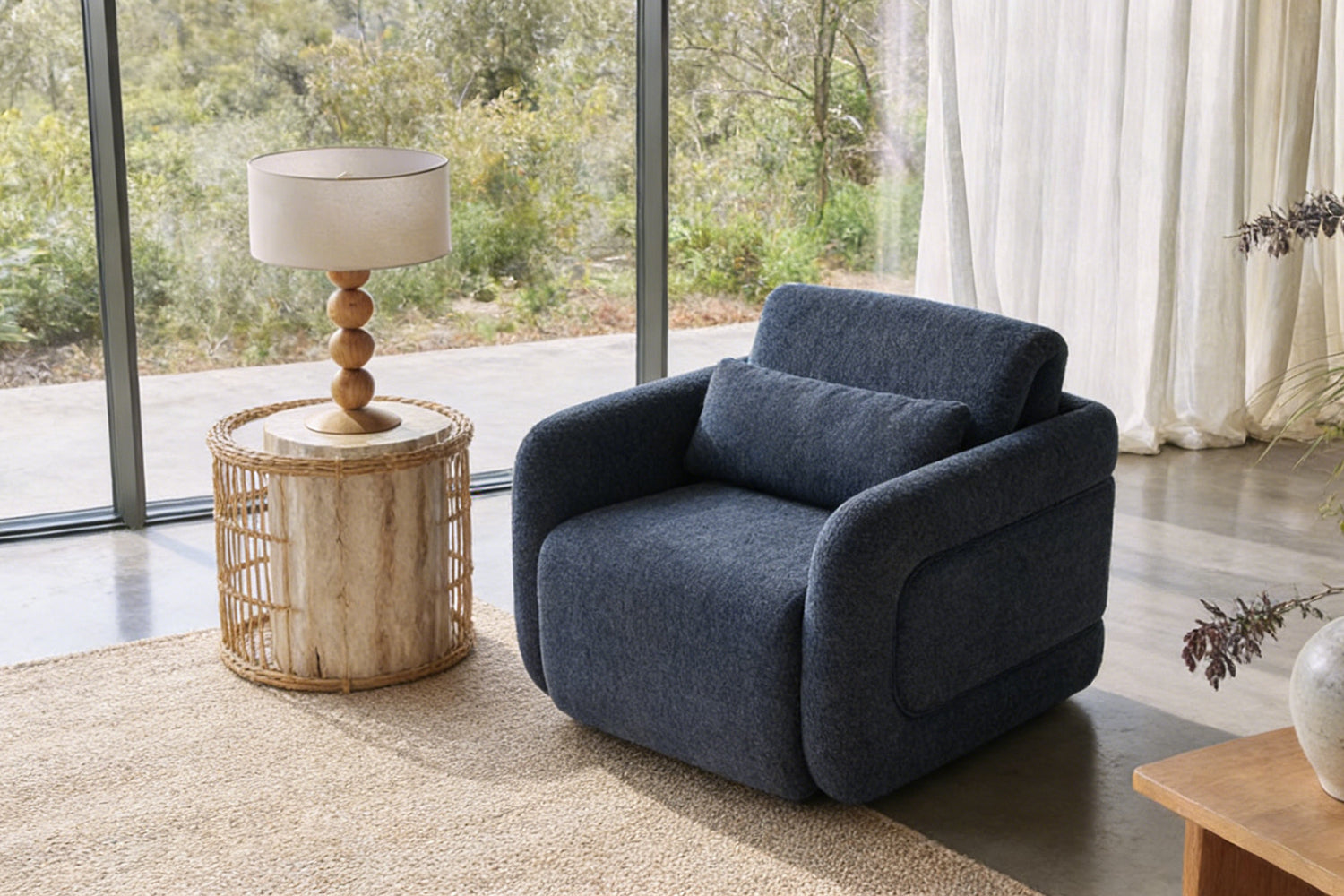 Stylish navy Fabric Leisure Chair placed in a bright living room next to a woven side table and floor lamp, adding warmth and texture