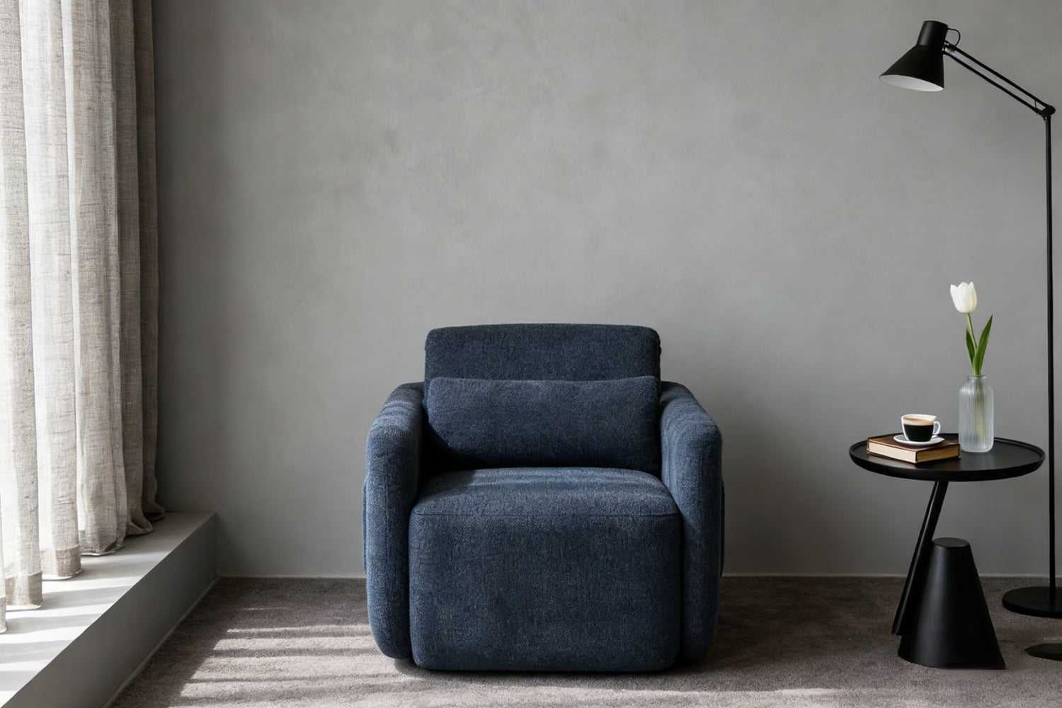 Sleek navy blue leisure chair against a neutral gray wall, perfect for contemporary minimalist interiors with its soft curved silhouette