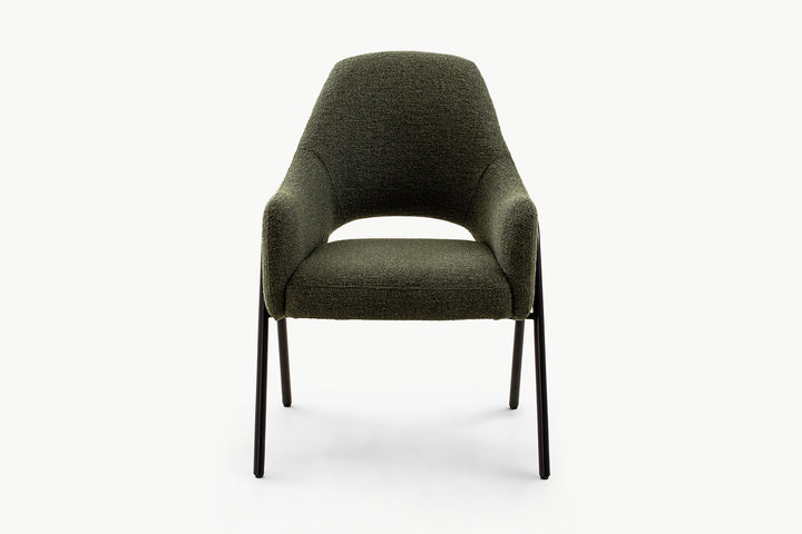 Sleek olive dining chair in textured boucle fabric with contoured back, padded seat, and black metal legs, delivering modern elegance and timeless style.