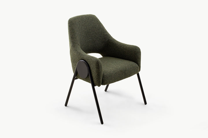 Three-quarter view of the olive dining chair featuring soft, boucle-textured upholstery in deep olive, rounded armrests, and modern black metal base with circular detail, perfect for upscale dining rooms.