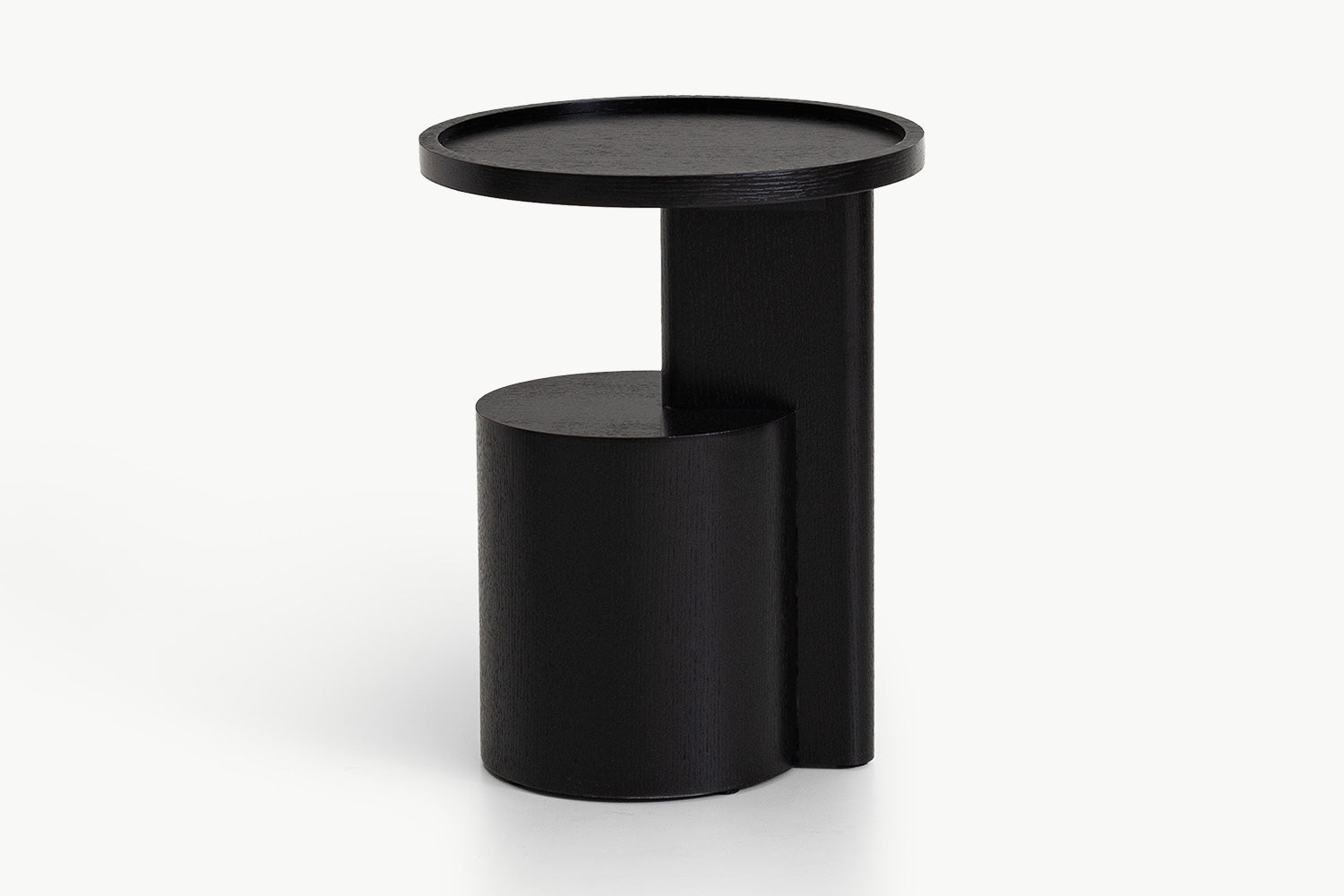 Detailed view of Oscar Side Table's unique half-cylinder lower shelf attached to the main column, highlighting robust joinery and stable footprint