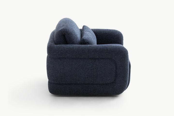 Back perspective of the plush navy leisure chair, highlighting the generous padded backrest and seamless fabric upholstery